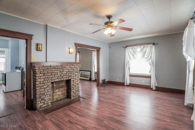 unfurnished living room featuring crown molding, a brick fireplace, ceiling fan, wood finished floors, and baseboards