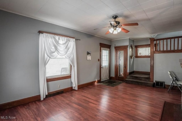 foyer featuring dark wood-style floors, visible vents, baseboards, and a ceiling fan