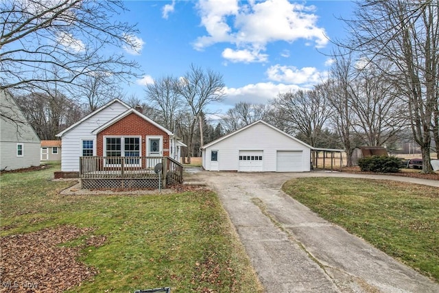 bungalow-style home featuring a garage, a front lawn, an outbuilding, and a wooden deck