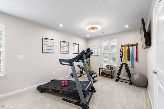 workout area featuring light carpet, baseboards, and recessed lighting