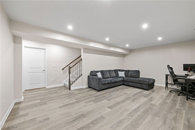 living area with light wood-style floors, recessed lighting, stairway, and baseboards