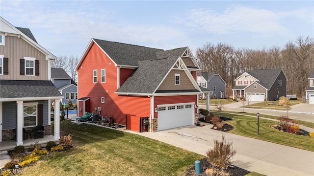 craftsman inspired home with a garage, driveway, roof with shingles, a residential view, and a front lawn