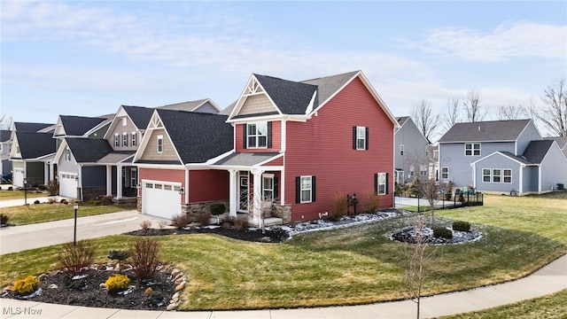 craftsman house with a garage, driveway, a residential view, and a front lawn