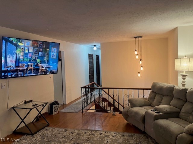 living area featuring a textured ceiling and wood finished floors