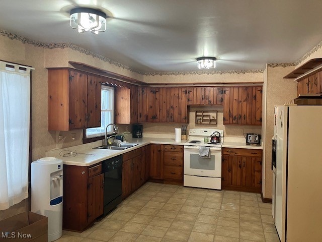 kitchen featuring light countertops, white appliances, and a sink