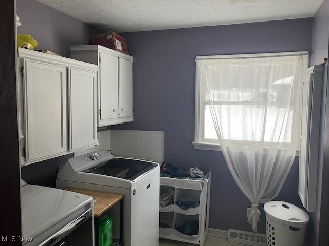 washroom with cabinet space, baseboards, visible vents, and a textured ceiling