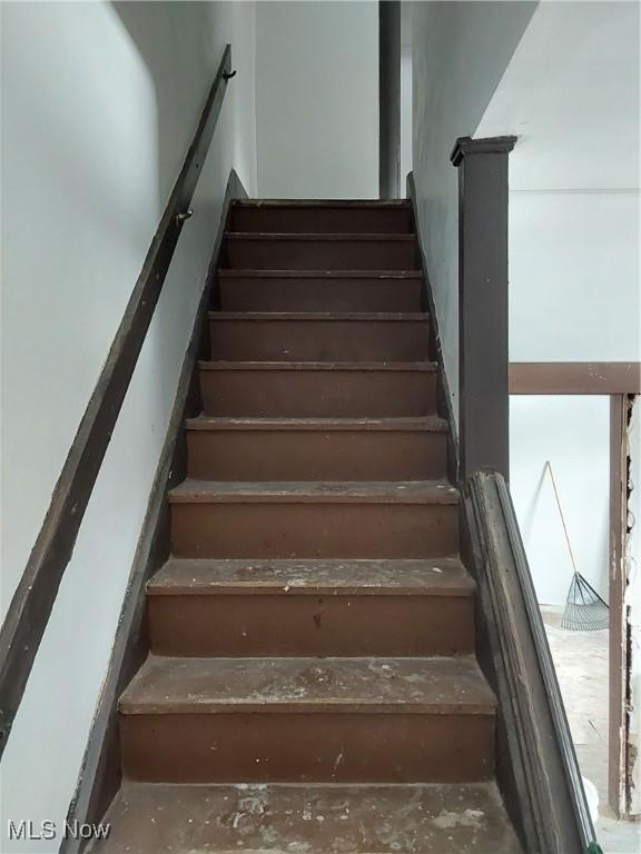 staircase with concrete floors