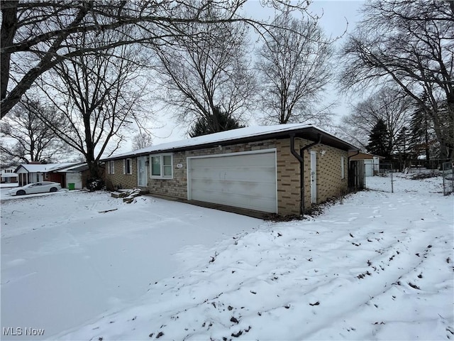 view of front of home featuring a garage and brick siding