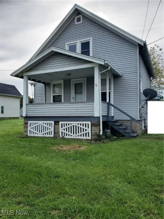 view of front of house with a porch and a front lawn