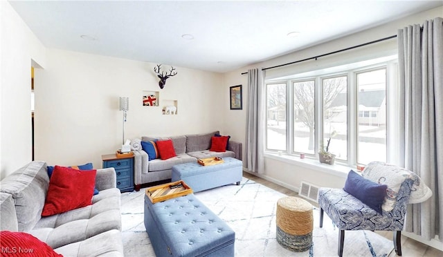 living room with visible vents and baseboards