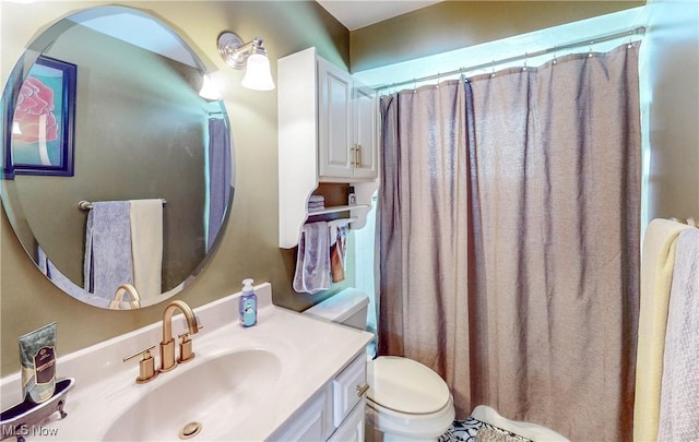 bathroom with toilet, curtained shower, and vanity