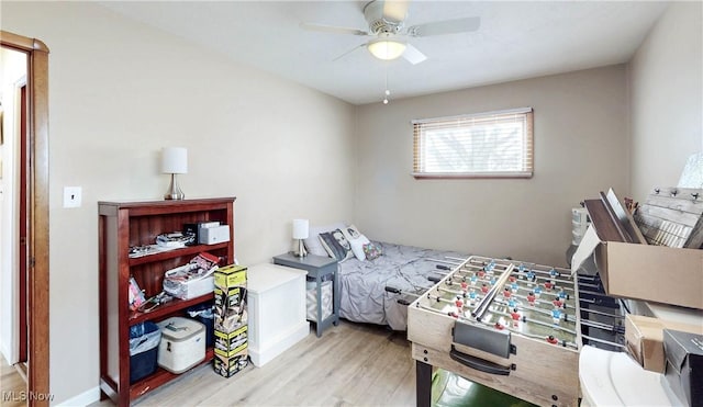 bedroom featuring ceiling fan, light wood-type flooring, and baseboards