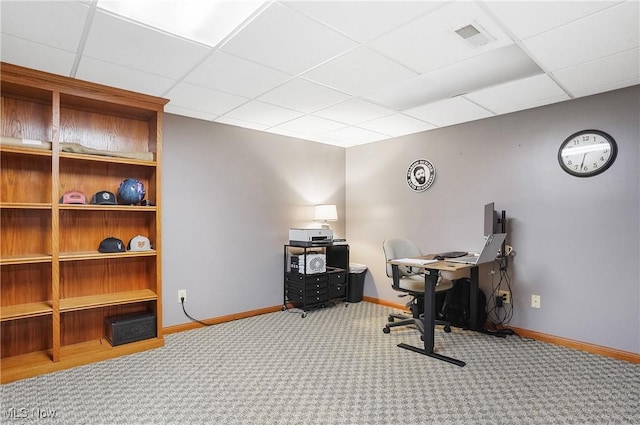 carpeted home office featuring a paneled ceiling, baseboards, and visible vents