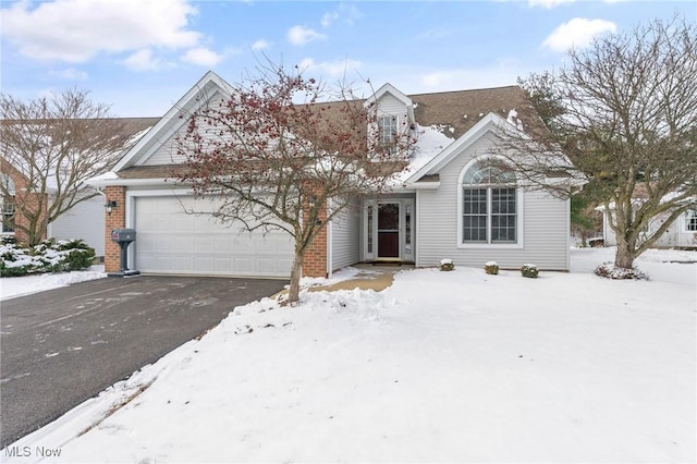 view of front of house with a garage and aphalt driveway