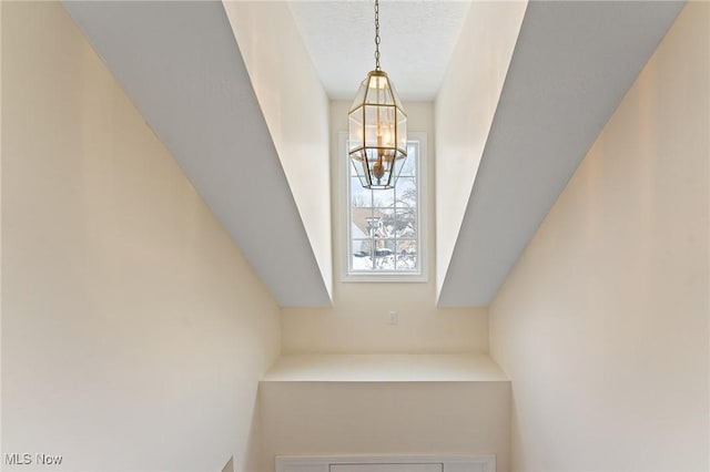 interior details featuring a chandelier and a textured ceiling