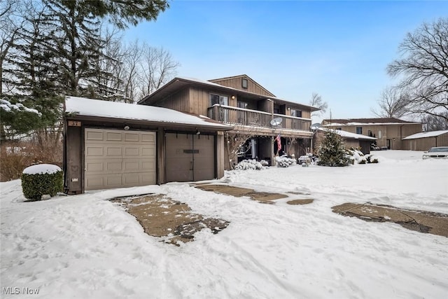 view of front of property with an attached garage and a balcony