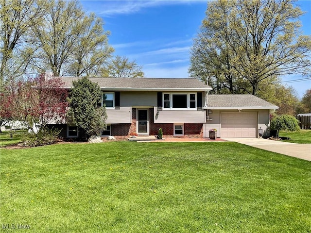 bi-level home featuring concrete driveway, brick siding, a front lawn, and a garage