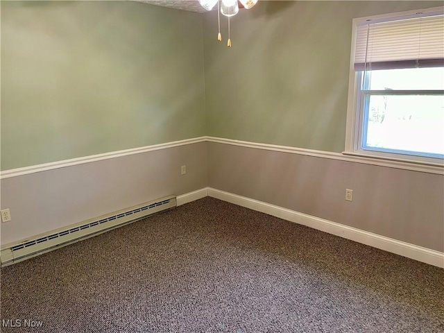 carpeted spare room featuring ceiling fan, baseboard heating, and baseboards