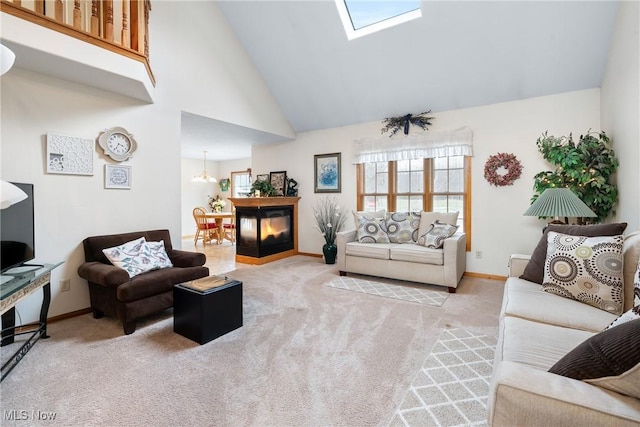 1925 N Lipkey Rd, North Jackson, OH 44451 - carpeted living room with a skylight, baseboards, high vaulted ceiling, and a chandelier