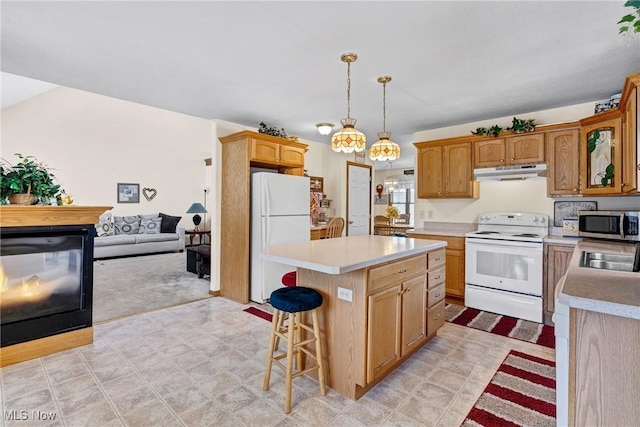 1925 N Lipkey Rd, North Jackson, OH 44451 - kitchen with white appliances, under cabinet range hood, light countertops, and a breakfast bar area