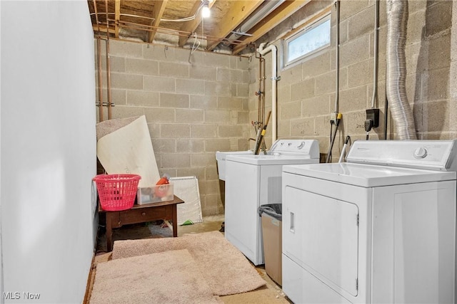 clothes washing area featuring laundry area and separate washer and dryer