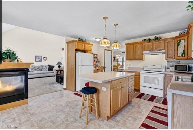 kitchen featuring a center island, light countertops, hanging light fixtures, white appliances, and under cabinet range hood