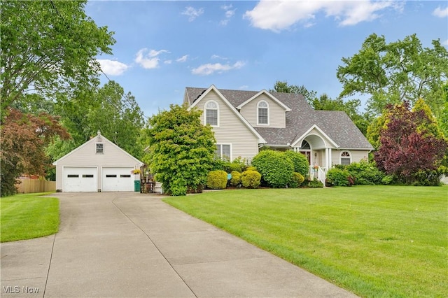 1925 N Lipkey Rd, North Jackson, OH 44451 - traditional-style home featuring a detached garage, an outbuilding, a front lawn, and a shingled roof