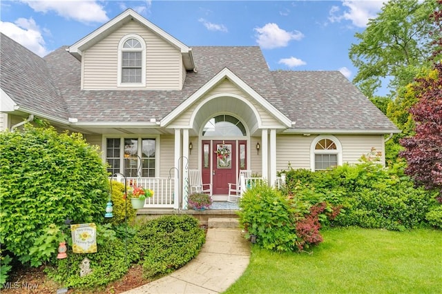 1925 N Lipkey Rd, North Jackson, OH 44451 - view of front of home with a shingled roof, a porch, and a front lawn