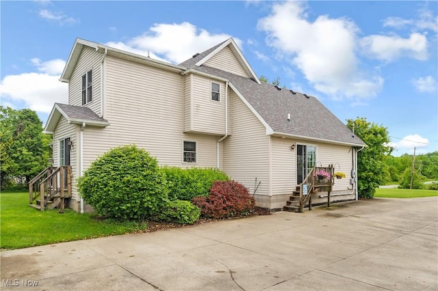 1925 N Lipkey Rd, North Jackson, OH 44451 - view of side of property featuring a shingled roof and a yard
