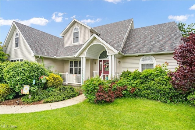 1925 N Lipkey Rd, North Jackson, OH 44451 - view of front of house featuring covered porch, roof with shingles, and a front yard