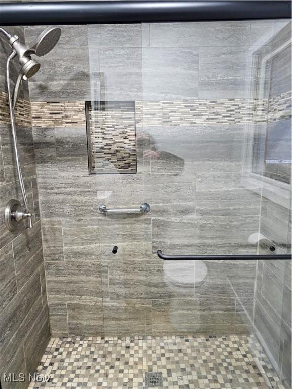 full bath with a shower stall