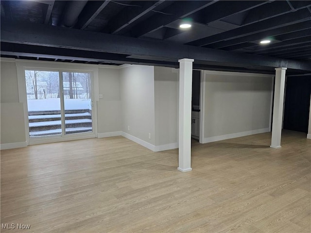 basement with light wood-type flooring and baseboards