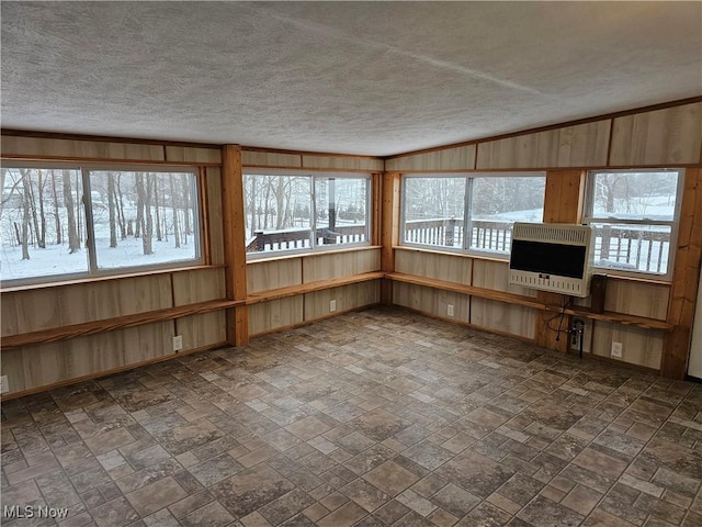 unfurnished sunroom featuring vaulted ceiling and heating unit