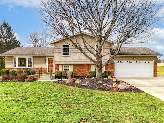 split level home with a garage, a front yard, brick siding, and driveway