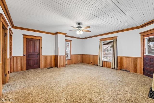 spare room featuring a wainscoted wall and wood walls