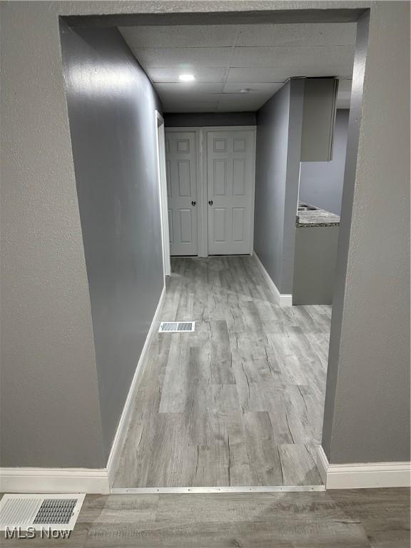 bathroom with shower / bath combination, tile patterned flooring, a drop ceiling, and toilet