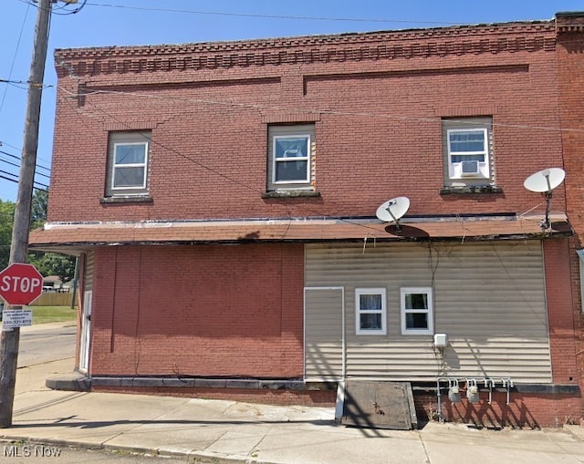 view of home's exterior featuring cooling unit and brick siding