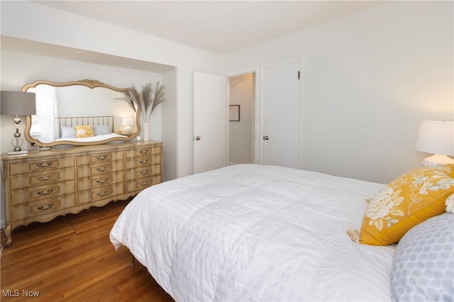 bedroom with dark wood-type flooring