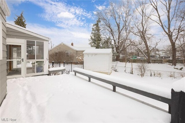 yard covered in snow featuring fence