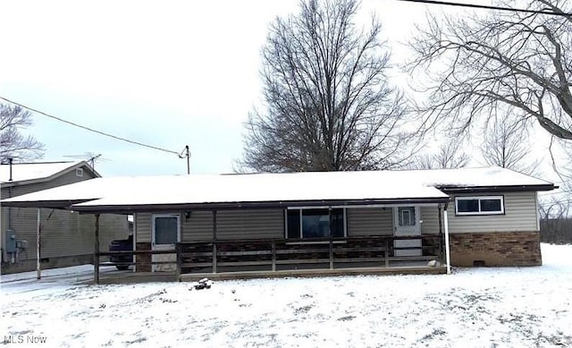 view of front facade featuring a carport and brick siding