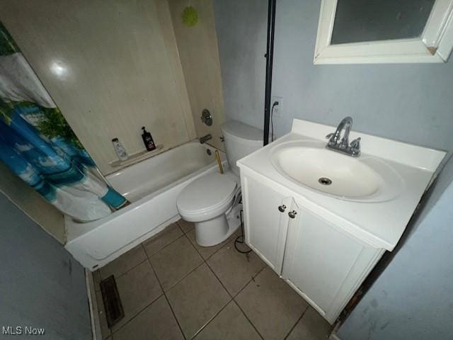 bathroom featuring toilet, tile patterned floors, shower / bath combo with shower curtain, and vanity