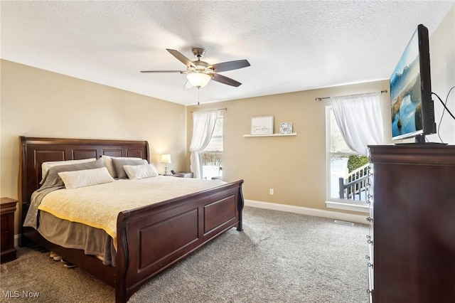 bedroom with baseboards, a ceiling fan, carpet flooring, and a textured ceiling
