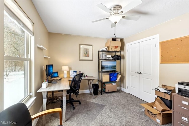 office area featuring carpet, baseboards, and ceiling fan