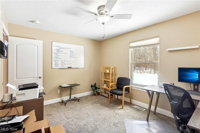 home office featuring carpet floors, baseboards, visible vents, and a textured ceiling