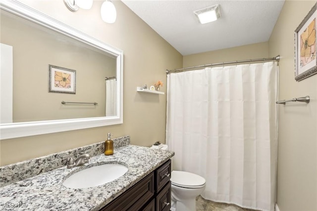 bathroom with toilet, vanity, and a shower with shower curtain