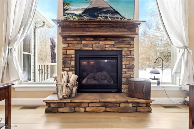 room details featuring wood finished floors, baseboards, and visible vents