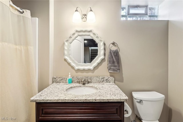 full bathroom featuring toilet and vanity