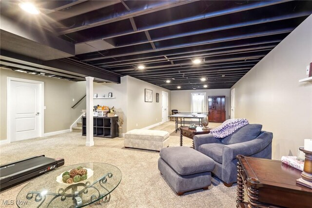 living room featuring carpet flooring, stairway, and baseboards