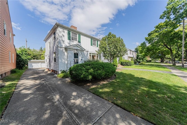 view of front of home featuring a front yard and an outbuilding