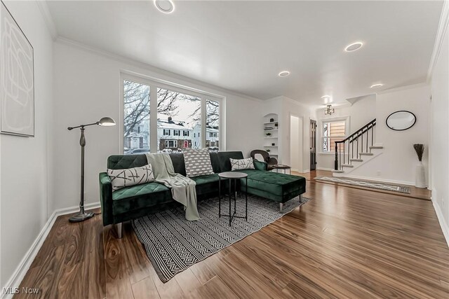 living room featuring stairs, wood finished floors, and a wealth of natural light